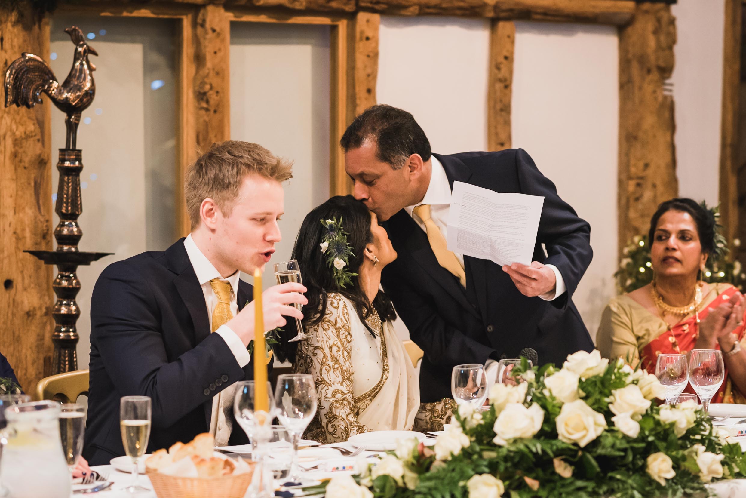 father of the bride kissing her forehead during his speeches at wedding in South farm