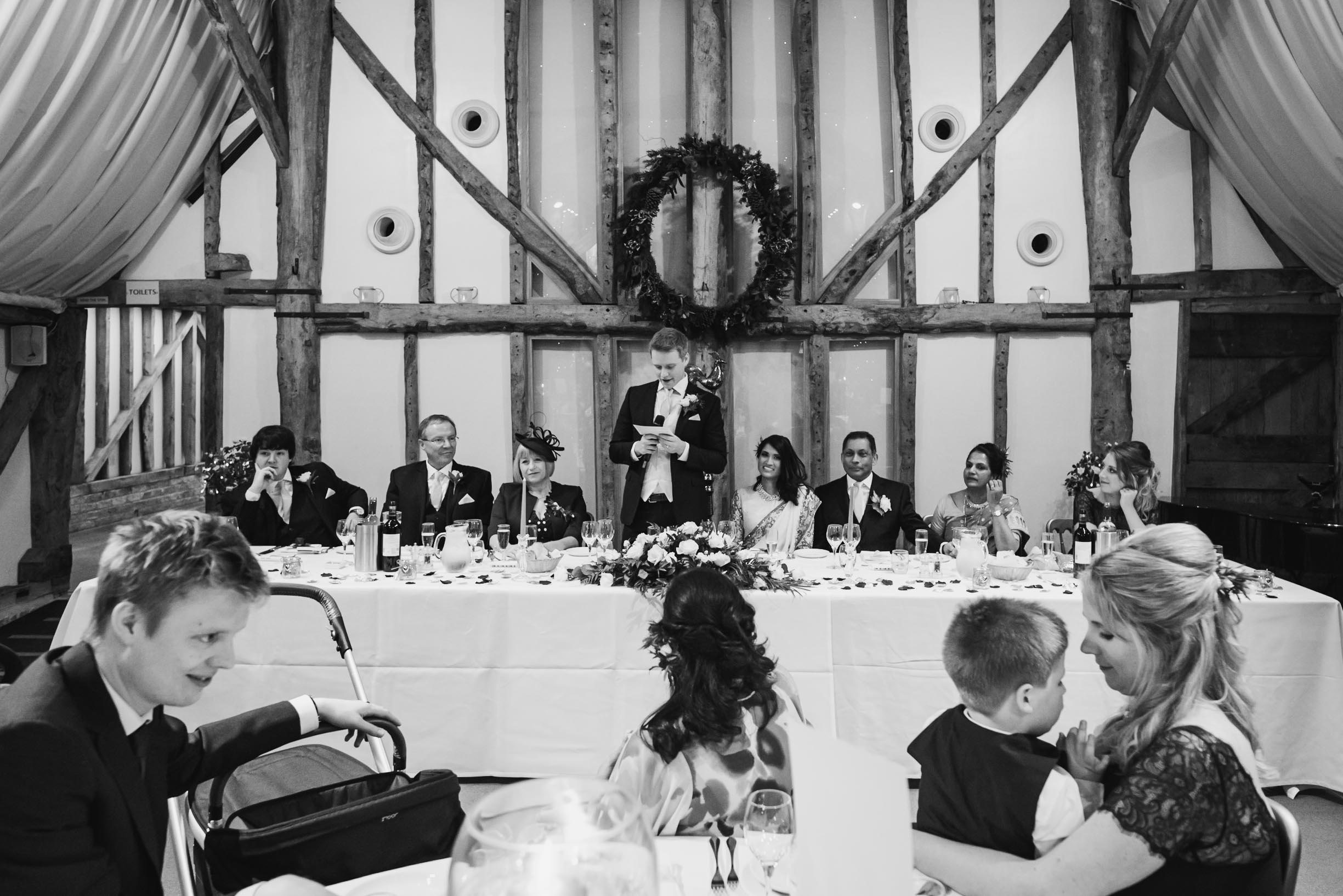 black and white picture of the groom in his speeches at his wedding in South farm